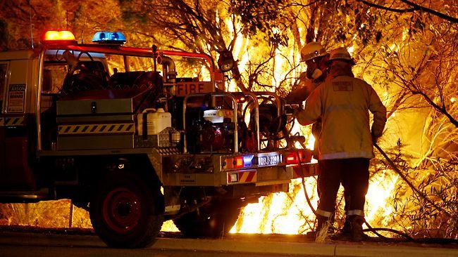 Firefighter putting out a bushfire